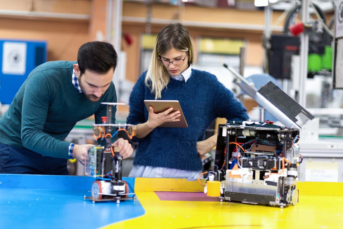 Young attractive students of mechatronics working on project